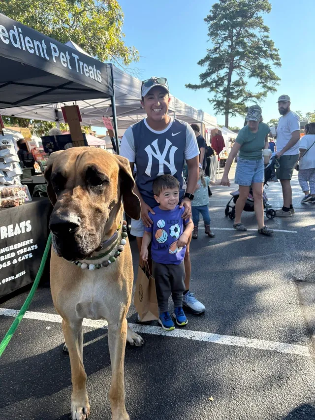 A young fan and his mom meeting Rex at the market