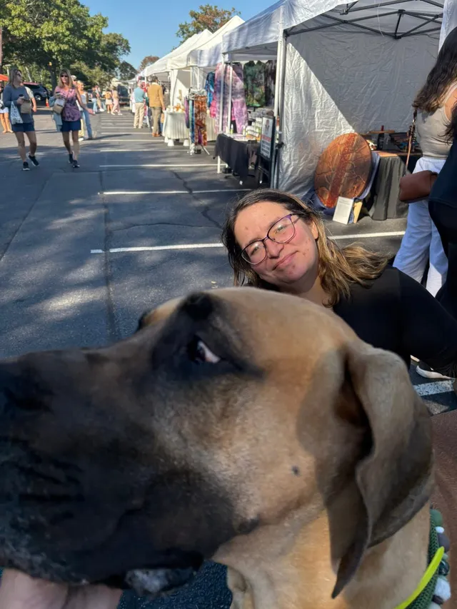 Rex photobombing a customer's picture at the market